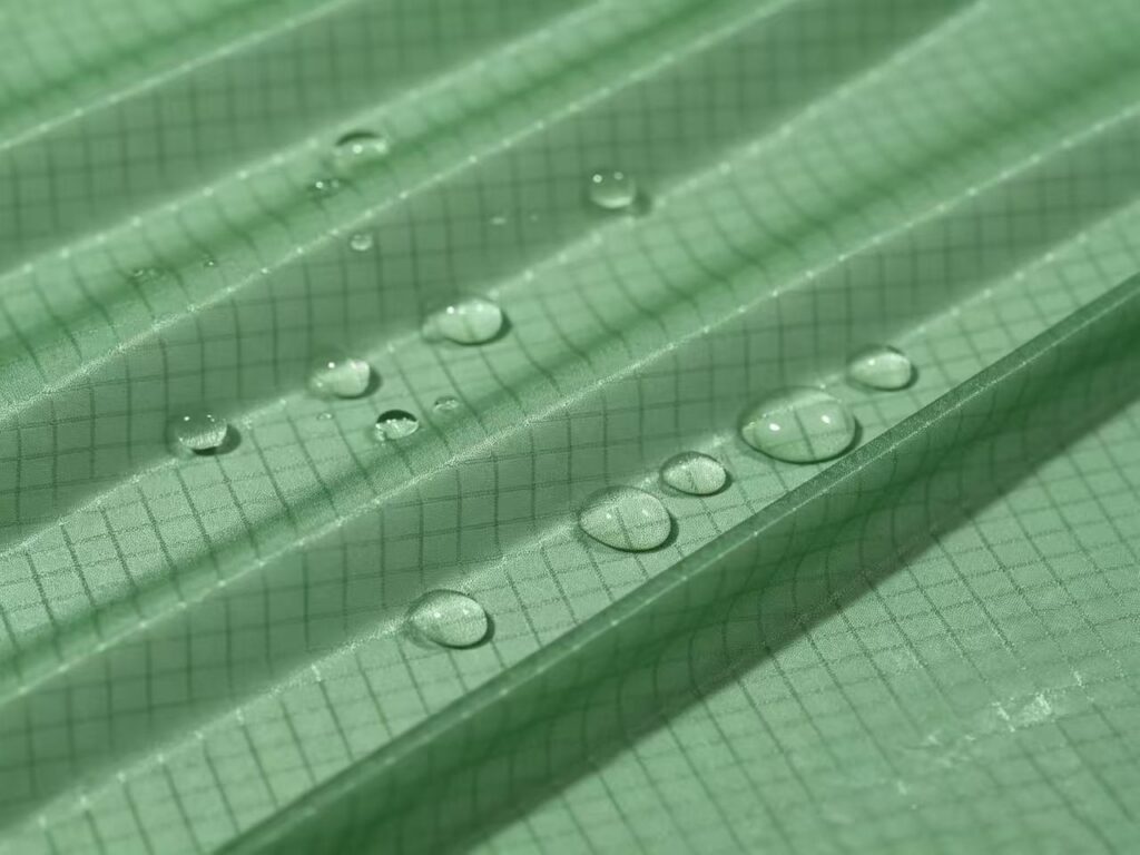Ripstop nylon taffeta fabric with lightweight grid construction for windbreakers, jackets, linings and technical apparel.