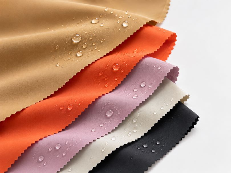 Nylon fabric samples with water-repellent finishes, showing different colors and fabric options for outdoor and performance apparel.