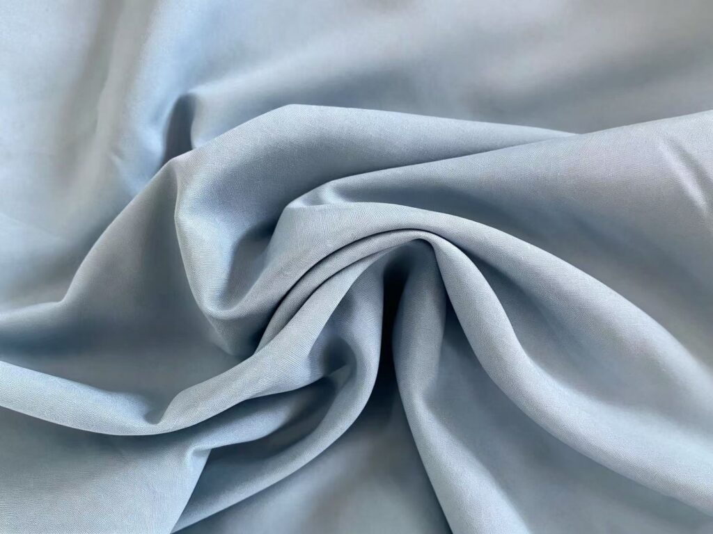 Semi-dull nylon taffeta fabric with smooth lightweight texture for jackets, linings, windbreakers and functional apparel.