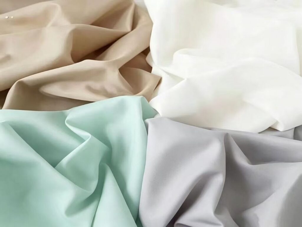Nylon taffeta fabric for garment linings with smooth surface, lightweight feel and easy layering.