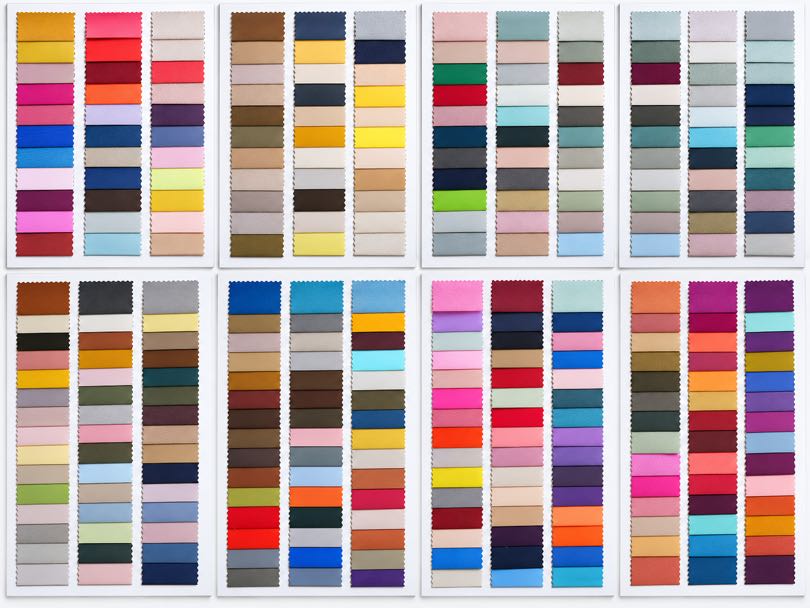 Polyester fabric color card showing a wide range of shades for custom apparel and textile applications.